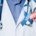 Doctor holding blue awareness ribbon